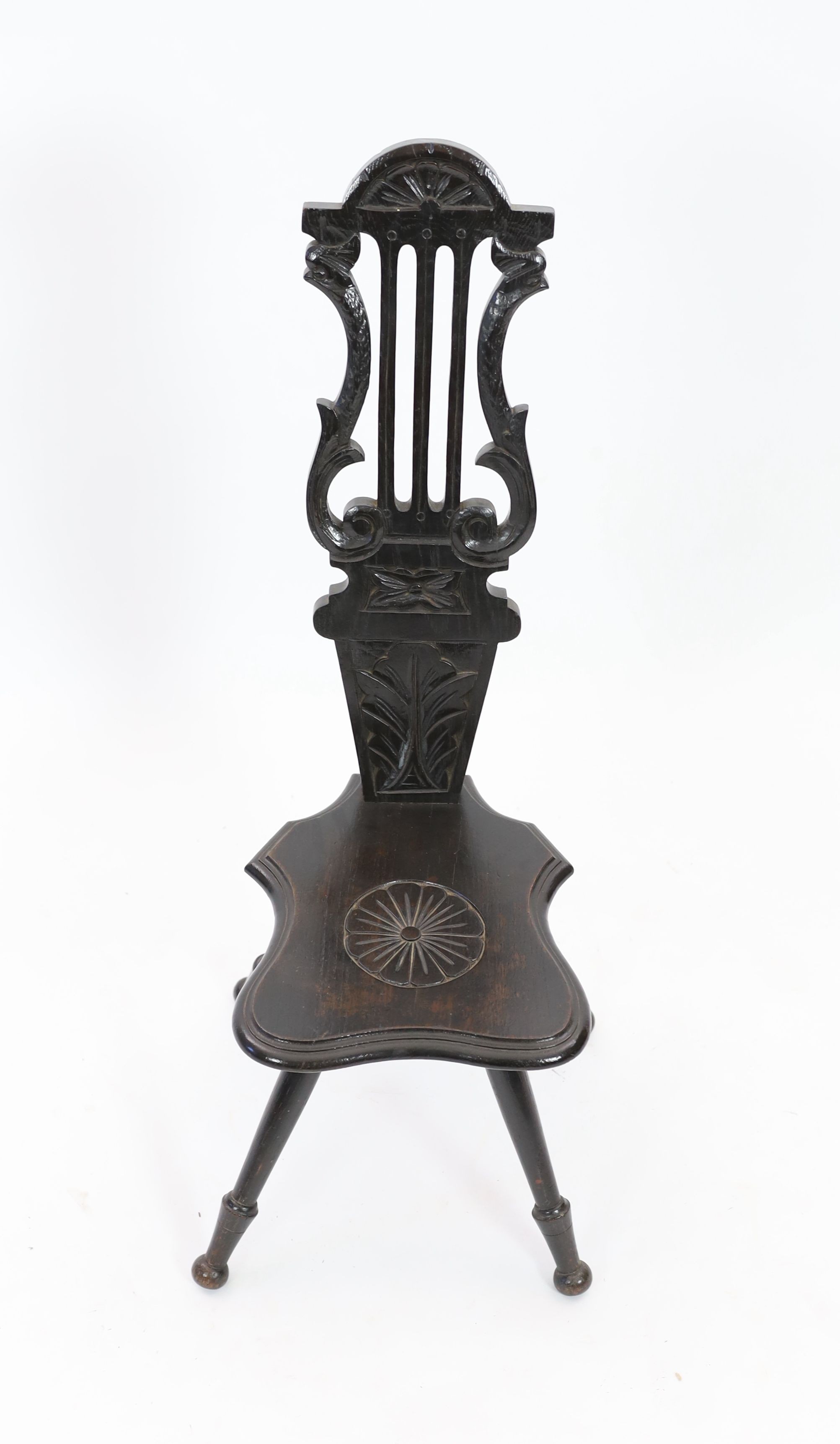 An early 20th century carved oak spinning chair, with lyre back, height 89cm